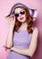 Young style redhead girl in sunglasses and purple clothes