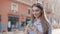 Young Stylish Attractive Caucasian Girl with Brown hair and Headband on it Using her Smartphone Scrolling and Smiling