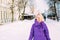 Young stylish blonde with glasses on the street in the snow.