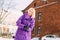 Young stylish blonde with glasses on the street in the snow.