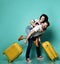 Young stylish couple man and woman in casual clothes are smiling posing with travel yellow suitcases Traveling