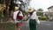 Young stylish couple in straw hats is walking the street