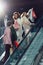 young stylish group of shoppers on escalator