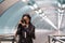 Young stylish korean girl make photos on camera in urban transport riding escalator while travelling