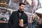 Young stylish man eating out sandwich at sandwich bar