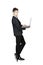 Young stylish man in tuxedo holding laptop