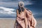 young stylish woman with fashionable boho accessories on the beach windy time