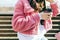 Young stylish woman in pink jacket, close-up shot. Youth culture