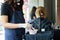 Young stylist preparing hair dye for coloring in beauty salon