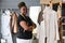 Young successful African American seamstress or tailor standng by mannequin
