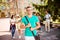 Young successful blond nerdy student is standing with bag and sm