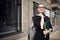 Young successful business woman in a business suit and glasses. On the street. Folder with documents in hand