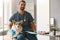 Young successful veterinarian in uniform sitting by workplace in clinics