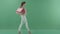 Young successful woman walks and texting on smartphone and holds the bags in profile on green screen