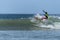 Young surfer breaking the wave, photographed in horizontal format with copy space available