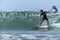 Young surfer breaking the wave, photographed in horizontal format with copy space available