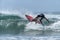 Young surfer breaking the wave, photographed in horizontal format with copy space available