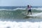 Young surfer breaking the wave, photographed in horizontal format with copy space available