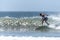 Young surfer breaking the wave, photographed in horizontal format with copy space available