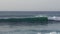 Young surfer catching his weave on ocean shore