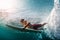 Young surfer dives under the ocean wave