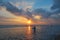 Young surfer silhouette with surfboard at beautiful sunset background, Kuta beach, Bali, Indonesia