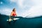 Young surfer waits wave in the ocean