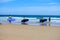 Young surfers train on Playa de Palombina Las Camaras in Celorio, Green coast of Asturias, North Spain with sandy beaches, cliffs