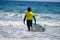 Young surfers train on Playa de Palombina Las Camaras in Celorio, Green coast of Asturias, North Spain with sandy beaches, cliffs