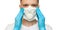 Young surgeon doctor in latex protective gloves puts on white protection mask on white background. Man in medical gloves and on