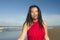 Young sweet and happy Asian Chinese woman in sarong at beautiful beach walking by the sea relaxed and blissful enjoying Summer