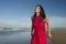 Young sweet and happy Asian Japanese woman in sarong at beautiful beach walking by the sea relaxed and blissful enjoying Summer