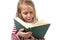 Young sweet little 6 or 7 years old with blond hair girl reading a book looking curious and fascinated