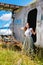 Young sweet woman in pin up style clothes stands by an abandoned plane