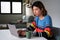 Young taiwanese man working at home with a laptop.