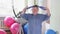 A young, talkative man with Down syndrome is engaged in sports exercises with exercise machines in the gym