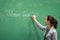 Young teacher writing on the board