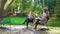 Young teachers preparing online training course while sitting in park