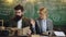 Young teachers standing in front of a chalkboard.