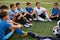 Young team of sportive boys take a break during football competition
