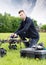 Young Technician Assembling UAV in Park