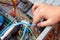 The young technician hold the cord for repairing the computer in his hand. Computer hardware, service, upgrade