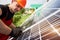 Young technician inspecting solar energy on a plot near the house