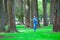 Young teen biracial girl walking under tall trees