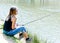 Young teen fishing on a river bank