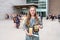 Young Teen Girl/Middle School student standing in front of school with awards and diploma after Grade 8/Middle school graduation c