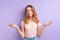 young teen girl misunderstanding, beautiful caucasian girl in casual wear shrugging, isolated on purple background