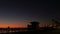 Young teen girls silhouettes, lifeguard watch tower, friends on pacific ocean beach, California USA.