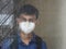 Young teen student wearing face mask and looking outside window.education and health care concept.