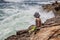 Young teenage boy fishing by the sea